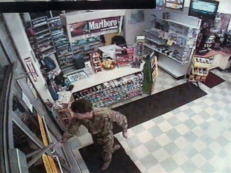 Security video image released by Oregon State Police on Wednesday, Jan. 26, shows a man identified as David Durham wearing camouflage clothing and a black beret in what appears to be a convenience store, about 30 minutes before Lincoln City police officer Steven Dodds was shot during a traffic stop Sunday night. 